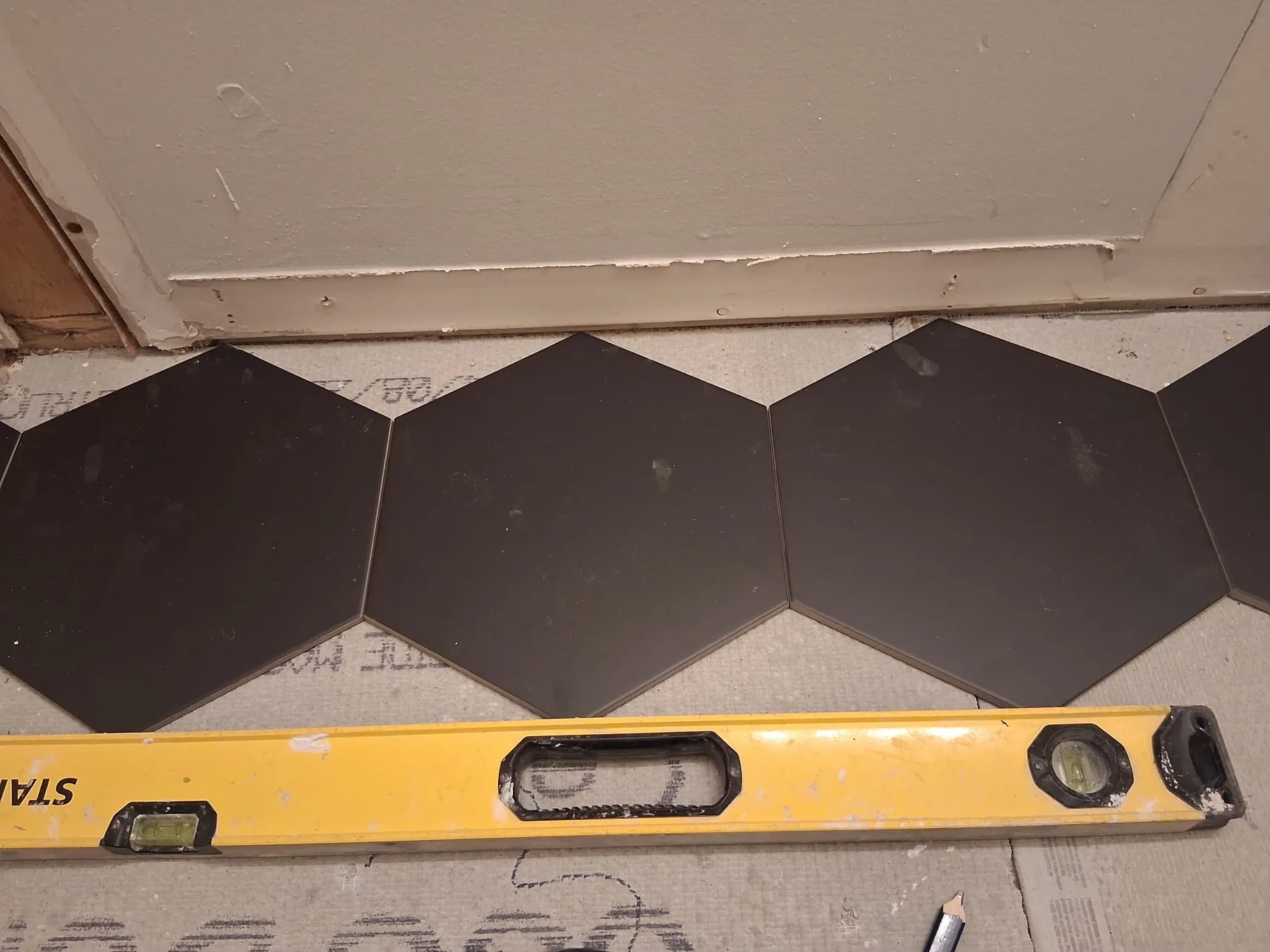 Shower remodeling with black hexagon floor tile